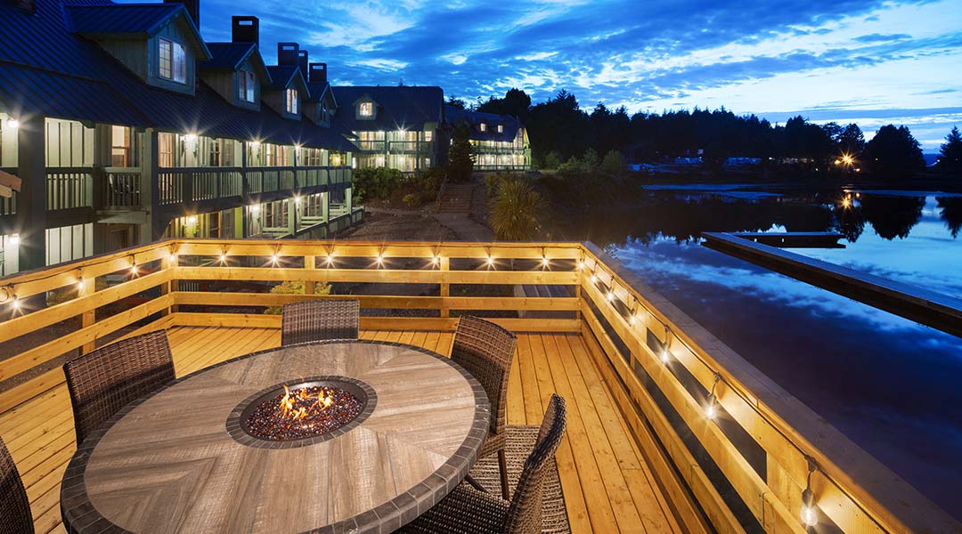 Outdoor seating area at the Canadian Princess Lodge featuring chairs and a firepit