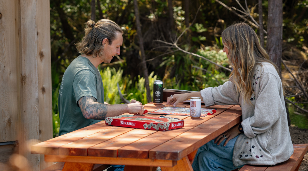 Couple sitting at the picnic table at Tsawaak RV Resort and Campground