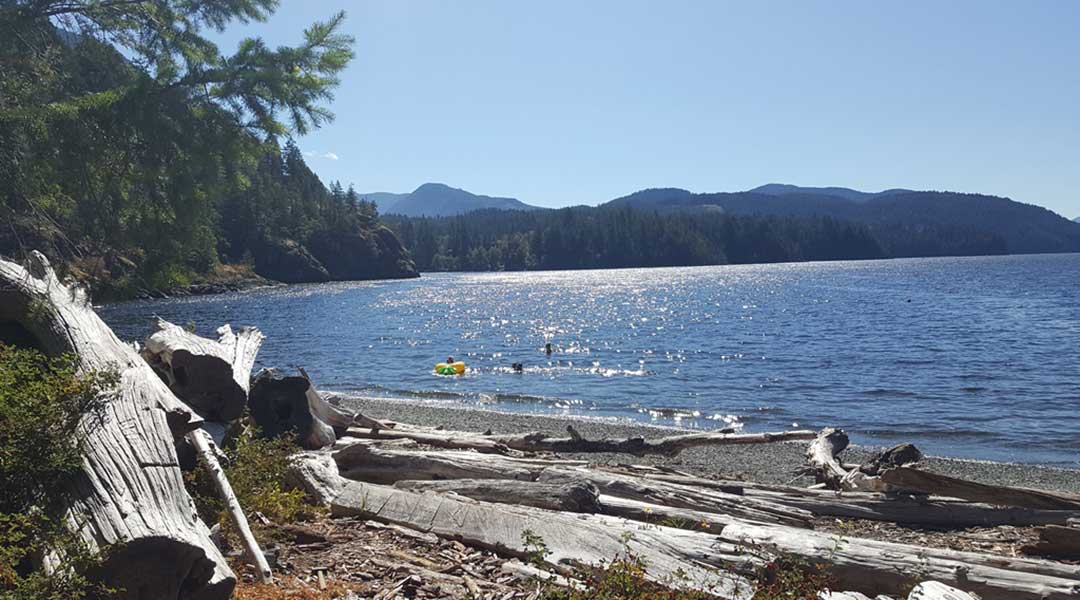People playing in the water at China Creek Beach near China Creek Campground in Port Alberni on Vancouver Island People playing in the water at China Creek Beach near China Creek Campground in Port Alberni on Vancouver Island