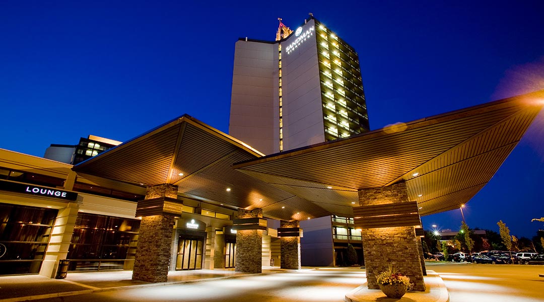The exterior building and entrance of the Sandman Signature Vancouver Airport Hotel and Resort at night in Richmond The exterior building and entrance of the Sandman Signature Vancouver Airport Hotel and Resort at night in Richmond