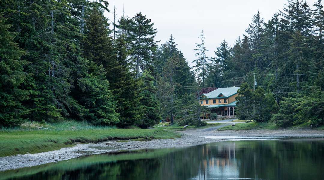 The exterior building of the Haida House at Tlall Bed and Breakfast by a lake in Haida Gwaii The exterior building of the Haida House at Tlall Bed and Breakfast by a lake in Haida Gwaii