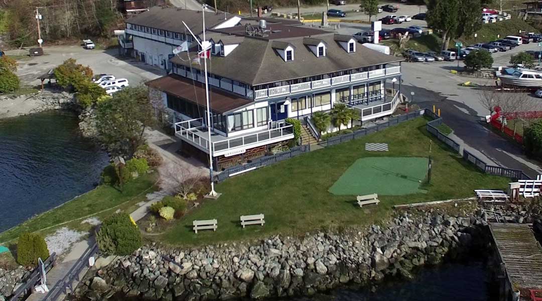 Aerial view of The Lund Resort at Klah Ah Men with front lawn and ocean near Powell River BC on the Sunshine Coast Aerial view of The Lund Resort at Klah Ah Men with front lawn and ocean near Powell River BC on the Sunshine Coast