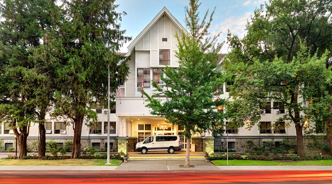Exterior of Huntingdon Manor in Victoria with trees in full bloom Exterior of Huntingdon Manor in Victoria with trees in full bloom