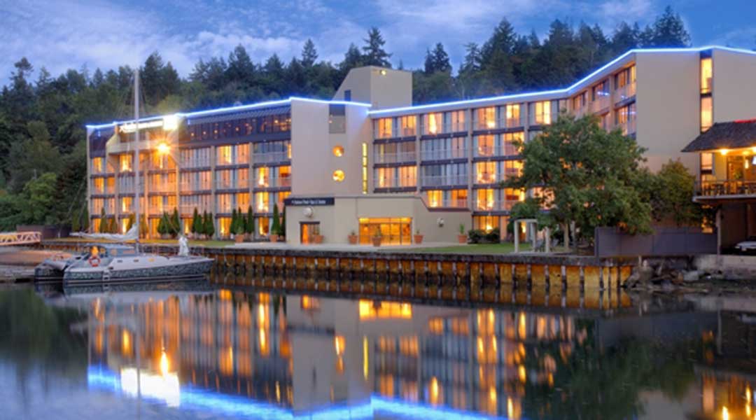 Exterior of the Oceanfront Suites at Cowichan Bay on the water at dusk Exterior of the Oceanfront Suites at Cowichan Bay on the water at dusk