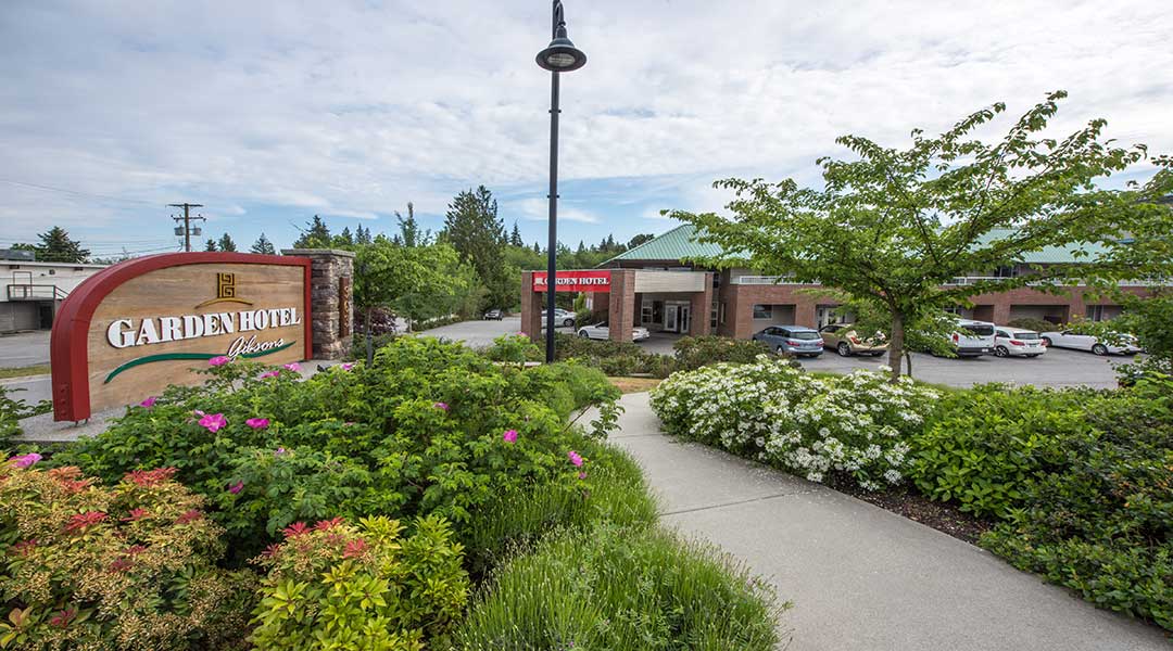 The exterior sign and parking lot of the Gibsons Garden Hotel on the Sunshine Coast The exterior sign and parking lot of the Gibsons Garden Hotel on the Sunshine Coast