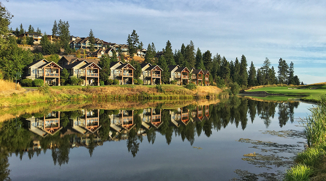 Predator Ridge villas and cottages across a still pond at Predator Ridge Resort in Vernon BC Predator Ridge villas and cottages across a still pond at Predator Ridge Resort in Vernon BC