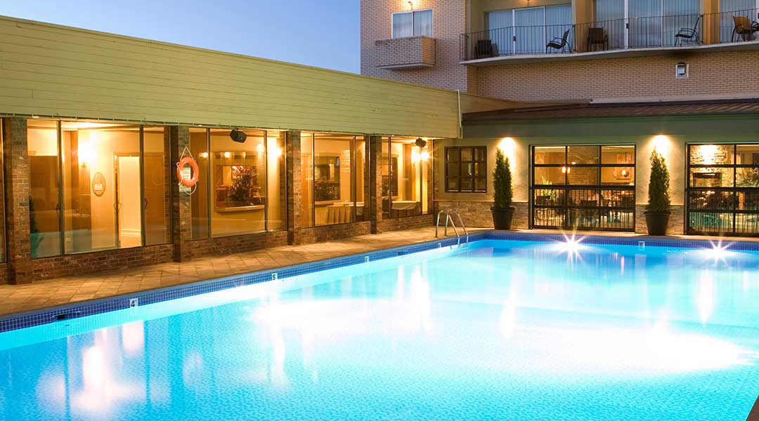 The outdoor pool in the evening at the Coast Capri Hotel in Kelowna in the Thompson Okanagan in the evening The outdoor pool in the evening at the Coast Capri Hotel in Kelowna in the Thompson Okanagan in the evening