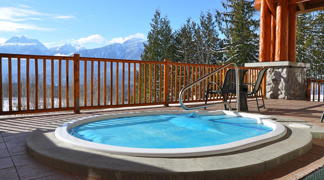 The jacuzzi on the outdoor patio with beautiful mountain views at the Coast Hillcrest Hotel in Revelstoke The jacuzzi on the outdoor patio with beautiful mountain views at the Coast Hillcrest Hotel in Revelstoke