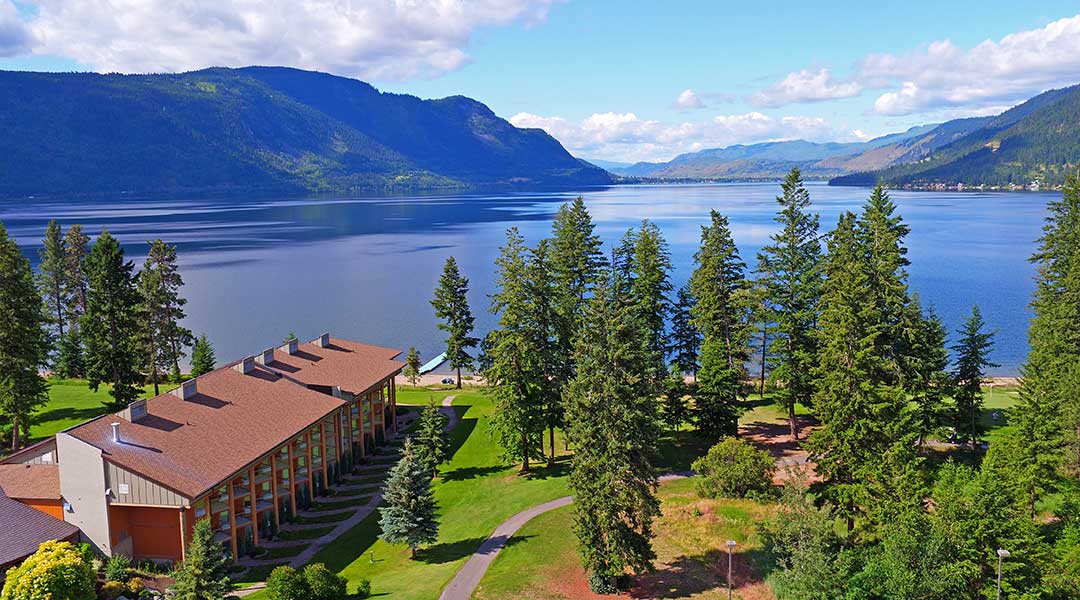 Aerial view of Quaaout Lodge and Spa with lake and trees in Chase BC Aerial view of Quaaout Lodge and Spa with lake and trees in Chase BC