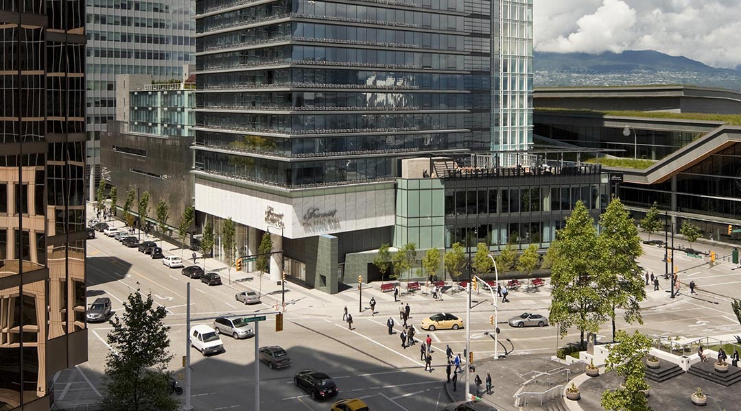 The exterior building of the Fairmont Pacific Rim in Downtown Vancouver and surrounding buildings