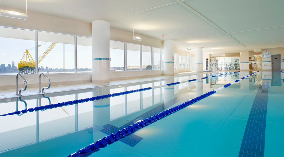 Indoor pool with windows looking out to ocean at the Pinnacle Hotel at the Pier in North Vancouver Indoor pool with windows looking out to ocean at the Pinnacle Hotel at the Pier in North Vancouver