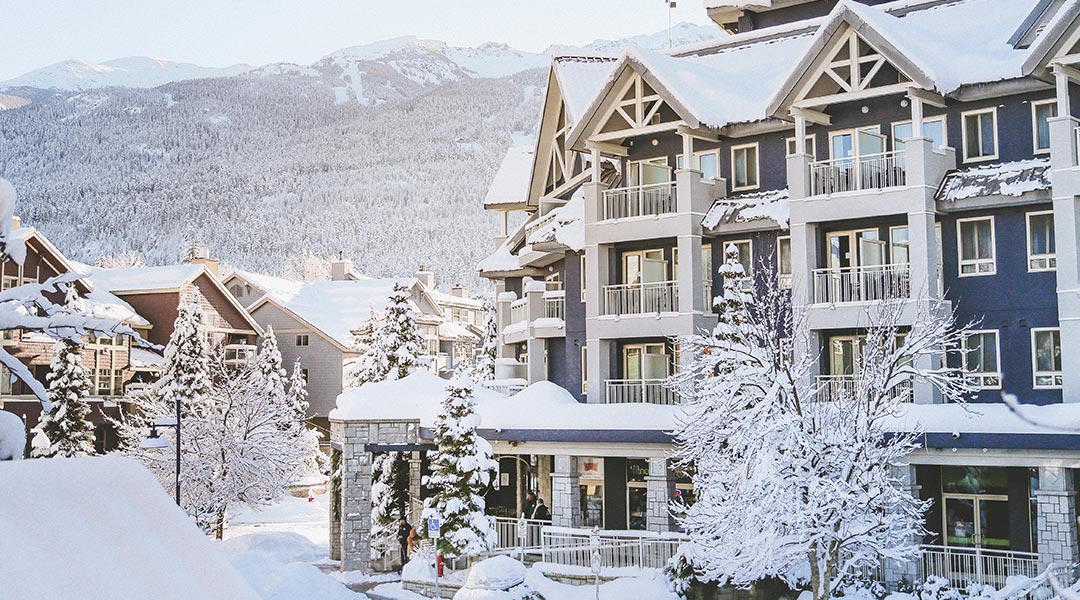 The exterior of the Summit Lodge Boutique Hotel in Whistler covered in snow
