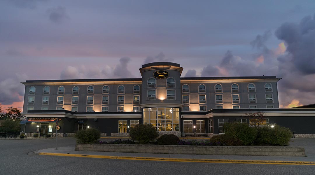 Front view of the exterior building of the Prestige Treasure Cove Hotel in Prince George during sunset Front view of the exterior building of the Prestige Treasure Cove Hotel in Prince George during sunset