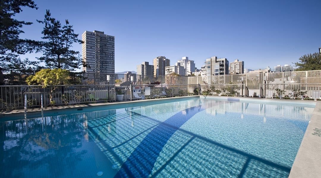 The outdoor pool with a city view at the Sandman Suites Vancouver Davie Street hotel in Downtown Vancouver