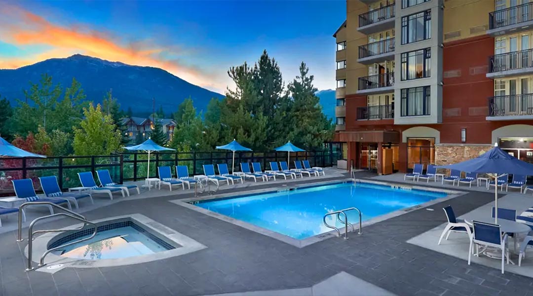 The outdoor pool with a mountain view at the Hilton Whistler Resort and Spa in the Coast Mountains