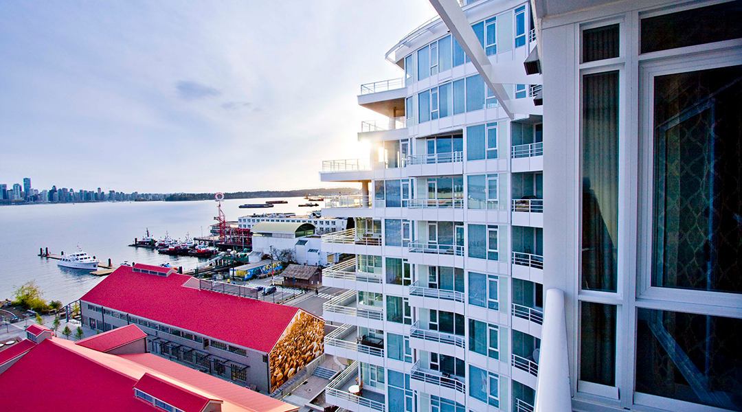 Balcony view of the side of the hotel and Lonsdale Quay with Vancouver Downtown in the distance from the Pinnacle Hotel at the Pier in North Vancouver Balcony view of the side of the hotel and Lonsdale Quay with Vancouver Downtown in the distance from the Pinnacle Hotel at the Pier in North Vancouver