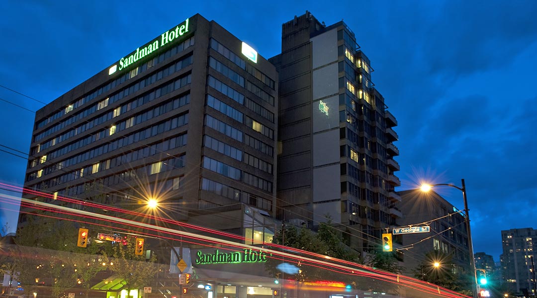 The exterior building of the Sandman Hotel Vancouver City Centre in Downtown Vancouver at night The exterior building of the Sandman Hotel Vancouver City Centre in Downtown Vancouver at night