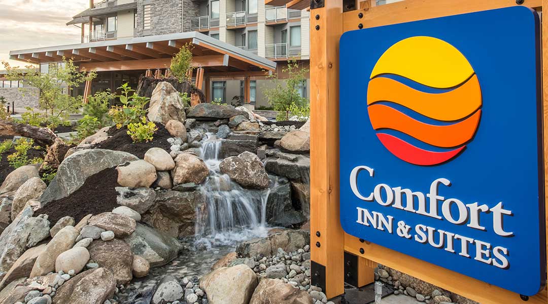 The exterior sign and building with a waterfall pond at the Comfort Inn and Suites Campbell River on Vancouver Island The exterior sign and building with a waterfall pond at the Comfort Inn and Suites Campbell River on Vancouver Island