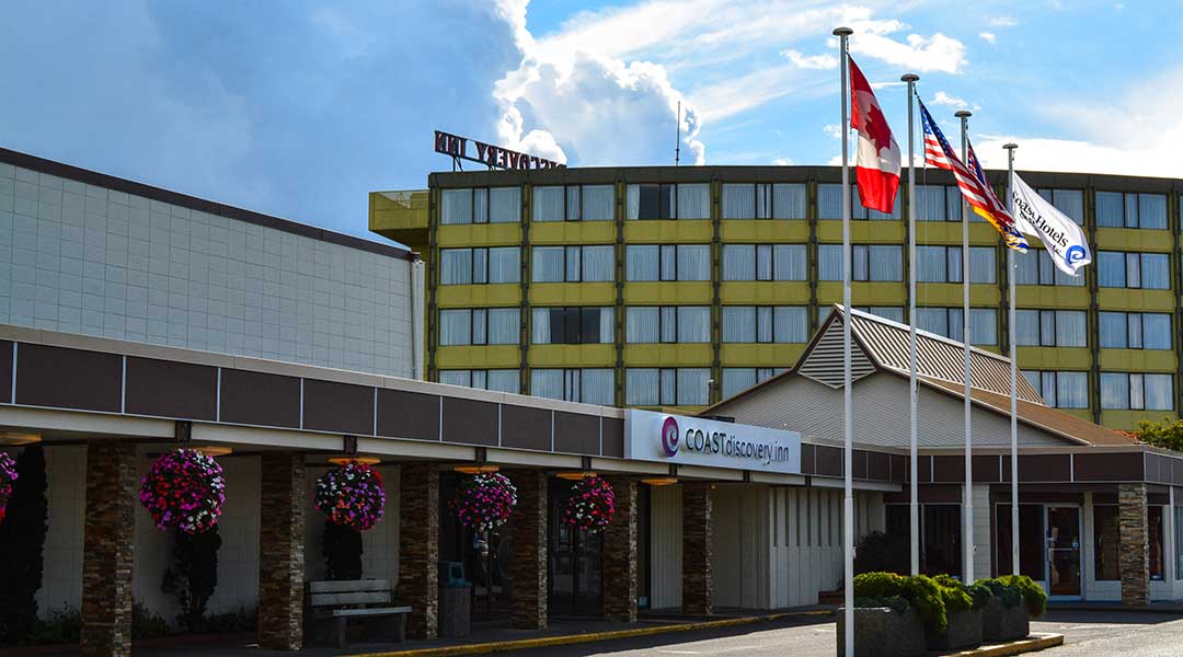 The exterior entrance and flag poles of the Coast Discovery Inn and Marina in Campbell River The exterior entrance and flag poles of the Coast Discovery Inn and Marina in Campbell River