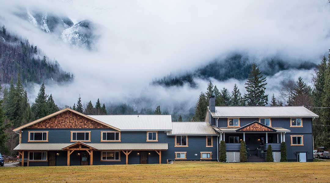 The exterior entrance of the Bella Coola Eagle Lodge on a foggy day The exterior entrance of the Bella Coola Eagle Lodge on a foggy day