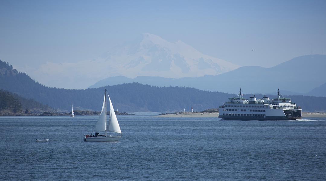 The ocean and mountain views with boats outside the Sidney Waterfront Inn and Suites on Vancouver Island The ocean and mountain views with boats outside the Sidney Waterfront Inn and Suites on Vancouver Island