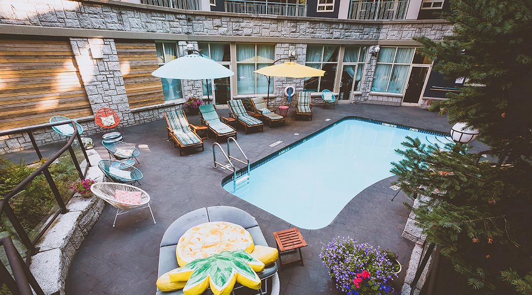 The outdoor pool with lounge chairs at the Summit Lodge Boutique Hotel in Whistler