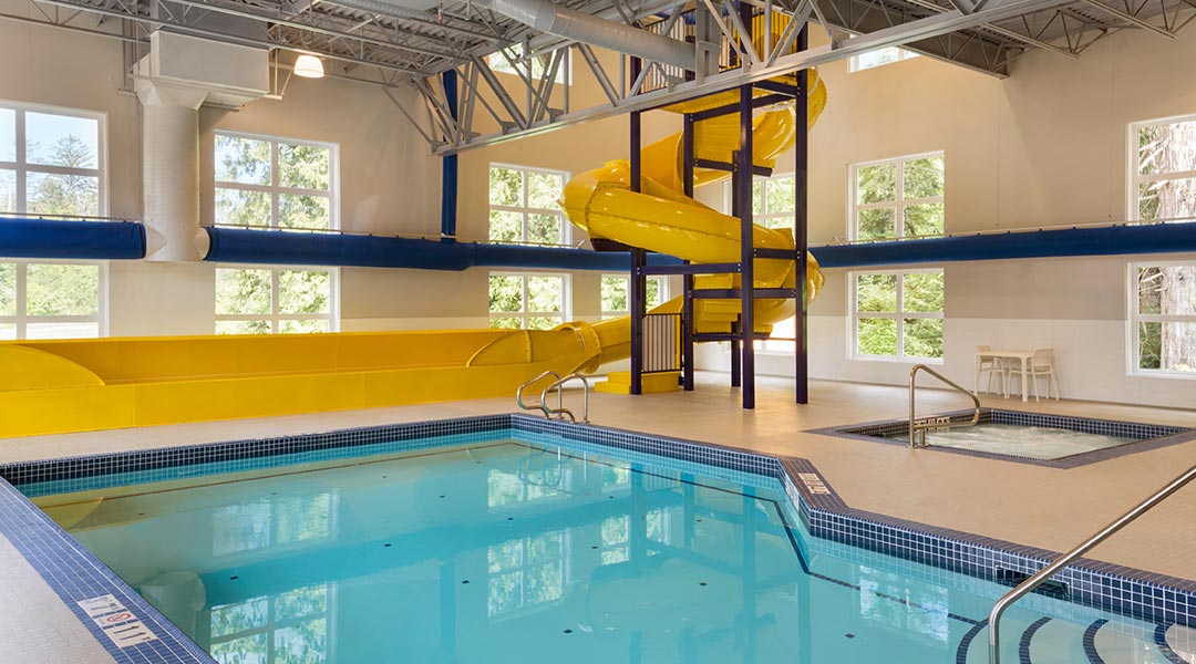 The indoor swimming pool and slide at the Microtel Inn and Suites by Wyndham Ladysmith Oyster Bay The indoor swimming pool and slide at the Microtel Inn and Suites by Wyndham Ladysmith Oyster Bay