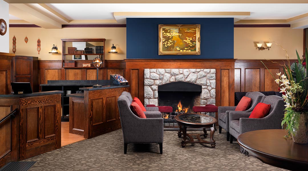 The interior lobby and seating area with a fireplace at the Huntingdon Manor in Victoria The interior lobby and seating area with a fireplace at the Huntingdon Manor in Victoria
