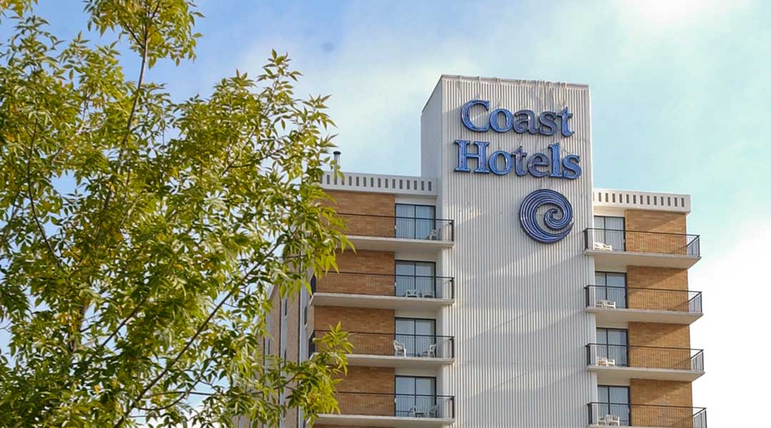 The exterior building and logo of the Coast Prince George Hotel by APA The exterior building and logo of the Coast Prince George Hotel by APA