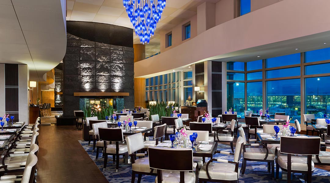 Dining tables and bar at the Globe YVR restaurant at the Fairmont Vancouver Airport hotel near YVR in Richmond