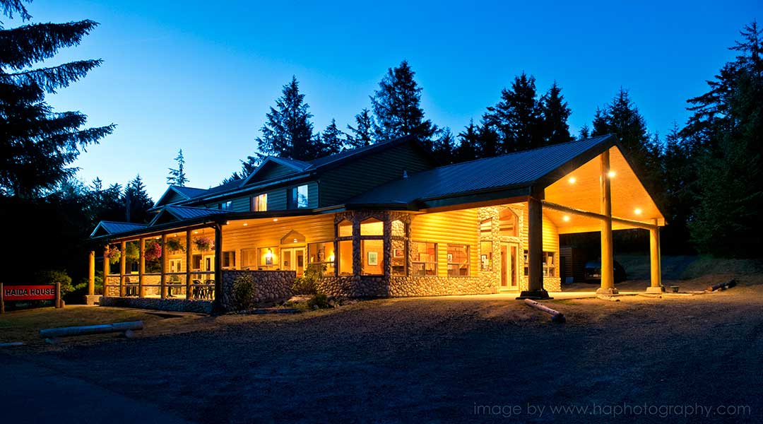 The exterior entrance and parking lot of the Haida House at Tlall Bed and Breakfast in Haida Gwaii at night The exterior entrance and parking lot of the Haida House at Tlall Bed and Breakfast in Haida Gwaii at night