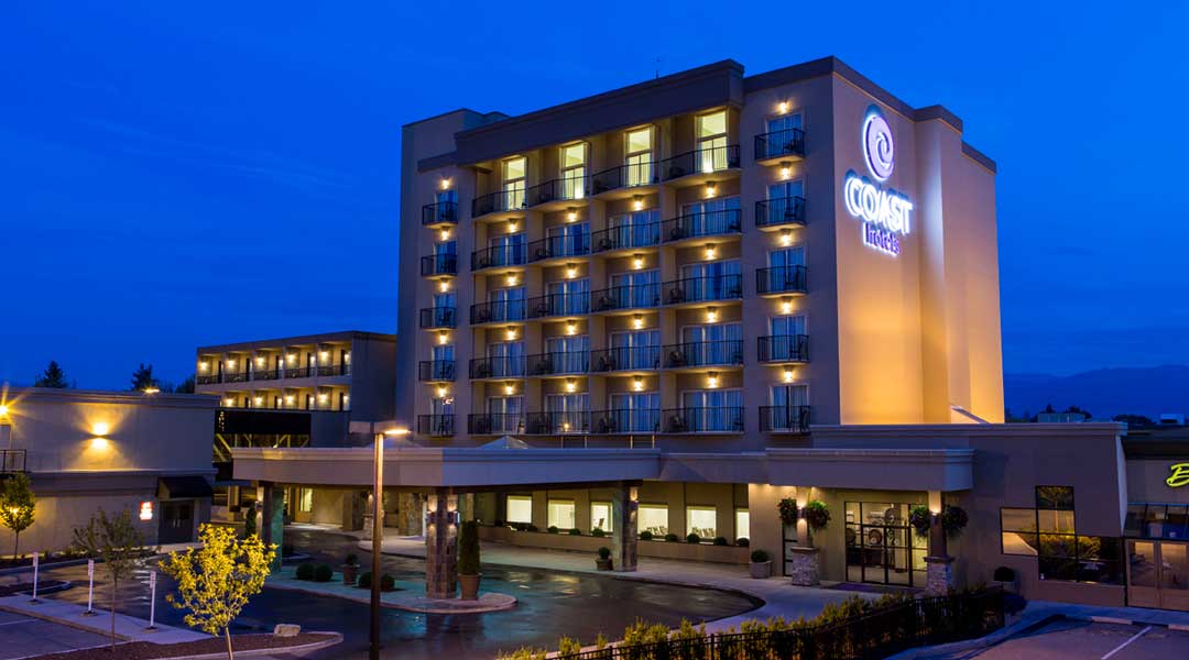The exterior entrance and building of the Coast Capri Hotel in Kelowna in the Thompson Okanagan in the evening The exterior entrance and building of the Coast Capri Hotel in Kelowna in the Thompson Okanagan in the evening