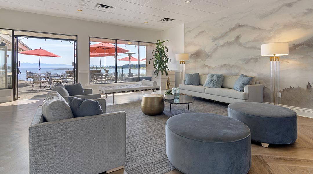 The lobby seating area with a patio and ocean views at the Bayside Oceanfront Resort in Parksville