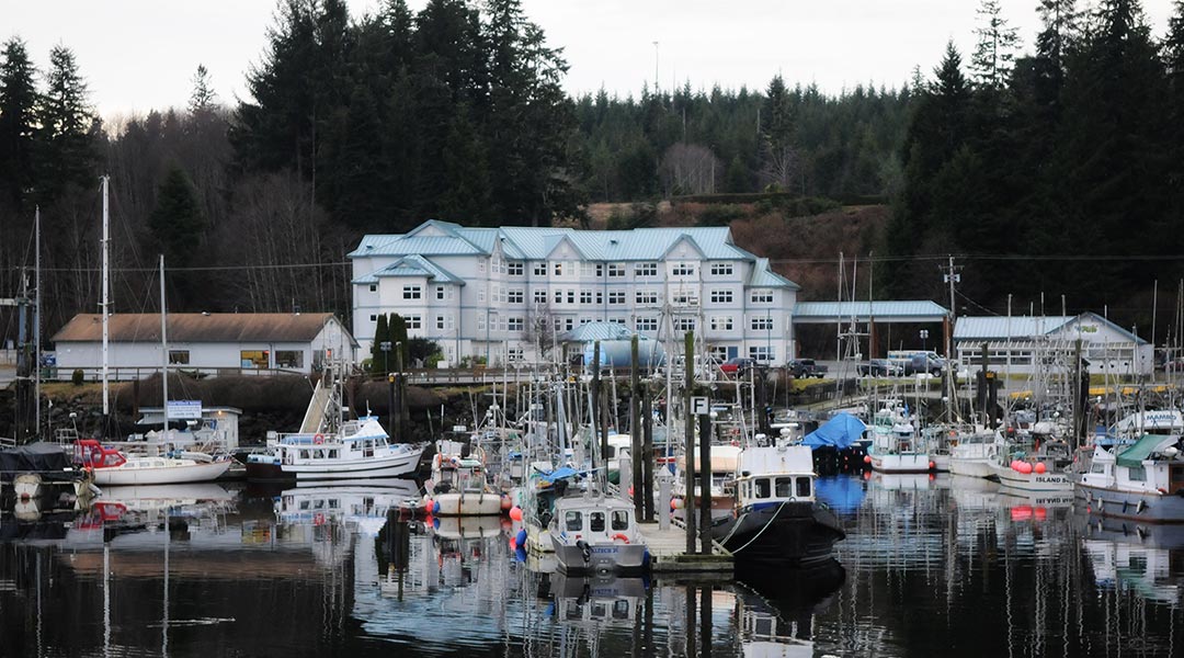 The marina with boats and the exterior of the Quarterdeck Resort and Marina in Port Hardy The marina with boats and the exterior of the Quarterdeck Resort and Marina in Port Hardy