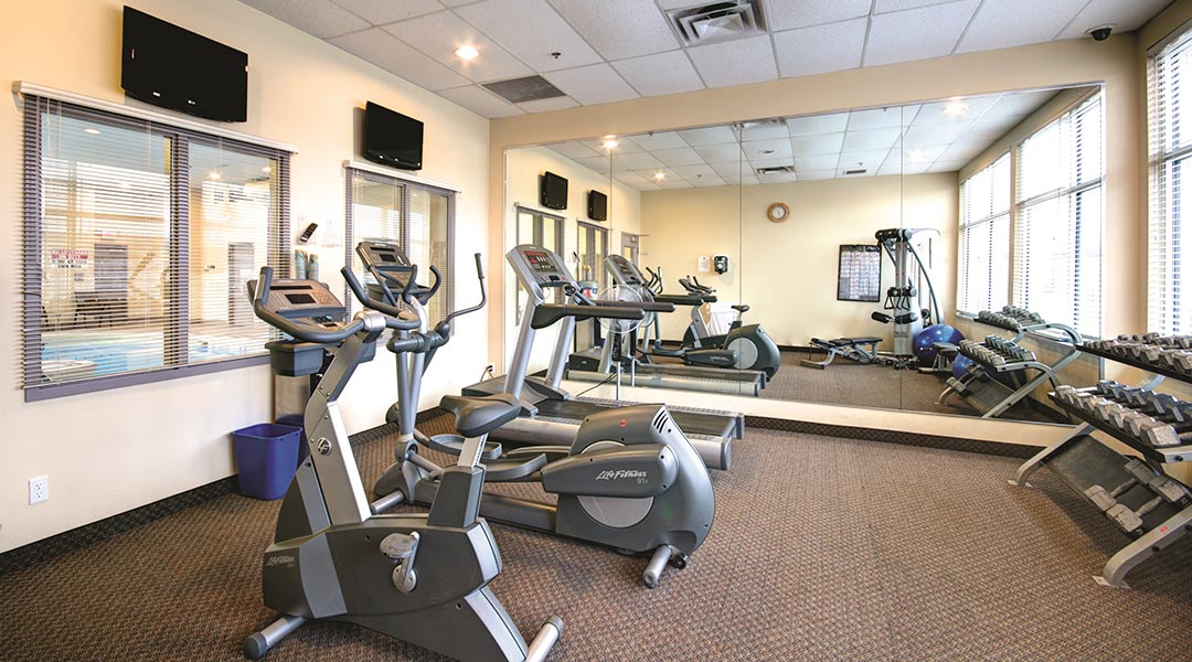 The fitness centre room with treadmills and dumbbells at the Prestige Treasure Cove Hotel in Prince George The fitness centre room with treadmills and dumbbells at the Prestige Treasure Cove Hotel in Prince George