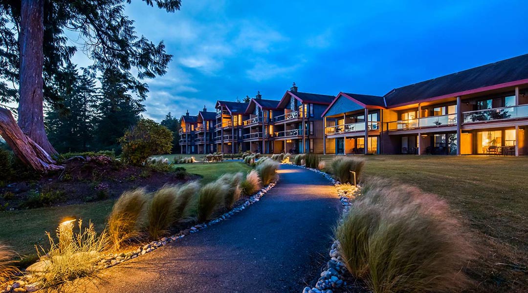 Pathway and exterior building of the Best Western Plus Tin Wis Resort at dusk in Tofino Pathway and exterior building of the Best Western Plus Tin Wis Resort at dusk in Tofino