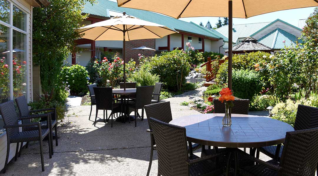 The outdoor patio with dining tables by the gardens at the Gibsons Garden Hotel on the Sunshine Coast The outdoor patio with dining tables by the gardens at the Gibsons Garden Hotel on the Sunshine Coast