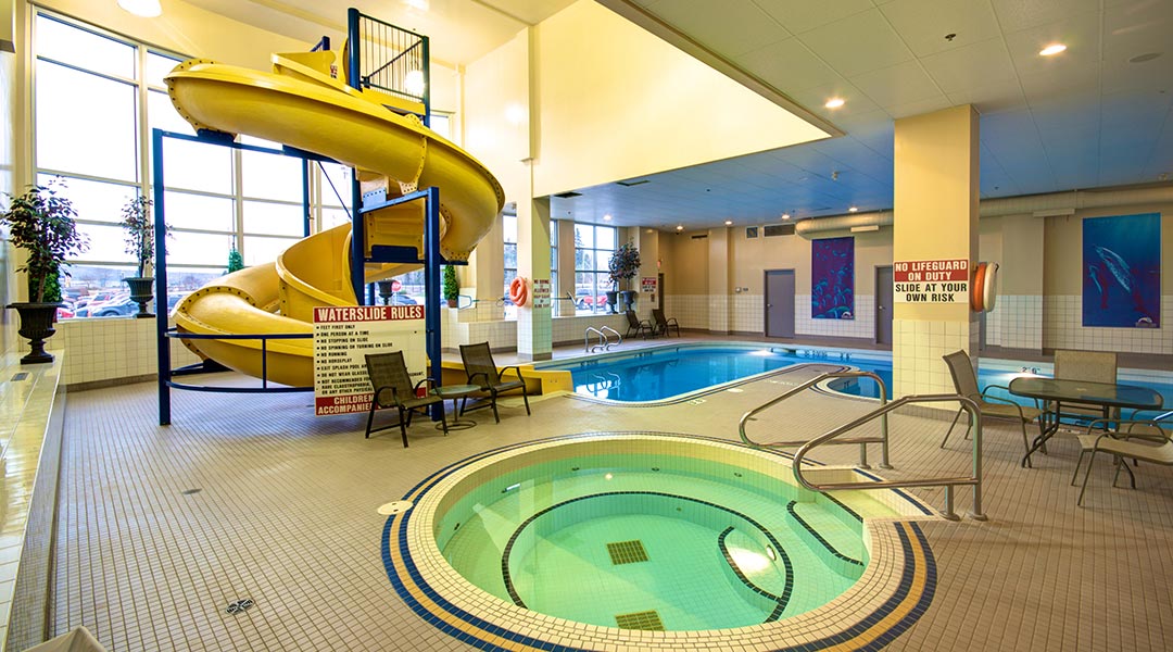 The swimming pool area with a hot tub and waterslide at the Prestige Treasure Cove Hotel in Prince George The swimming pool area with a hot tub and waterslide at the Prestige Treasure Cove Hotel in Prince George